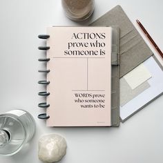 an open notebook sitting on top of a table next to a cup and pen, with the words actions prove who someone is