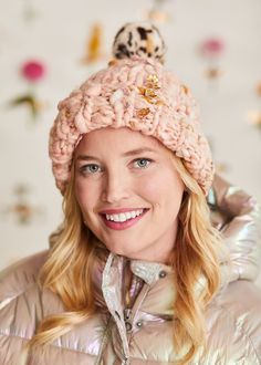 a woman wearing a pink hat and jacket