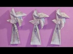 three origami birds made out of money