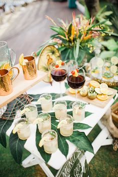 a table topped with glasses of wine and food