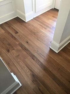 an empty room with hard wood flooring and white trim on the walls is shown