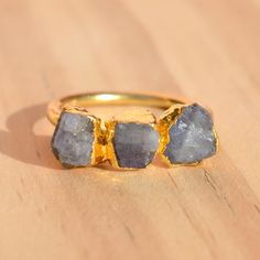 This raw Tanzanite brass ring was handcrafted with care to create this one-of-a-kind piece. You will receive a product similar to those photographed above. Each stone is unique, meaning no two rings will be identical. The process of making these rings is called electroforming. Cooper is deposited over the stone over 12-32 hours using electrical currents, we have to undergo many steps to craft these to perfection. Note : Ring Size Chart is given in the photos. Please measure your ring size before Unique Gold Crystal Ring With Raw Stone, Brass Crystal Ring With Gemstone For Gift, Gift Crystal Ring With Gemstone In Brass, Gift Brass Crystal Ring With Gemstone, Gold Amethyst Ring With Natural Stones As Gift, Gold Ring With Raw Stone For Healing, Unique Rings With Raw Stone For Gift, Unique Raw Rings As Gift, Unique Raw Rings For Gifts