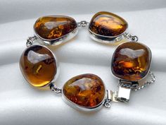 Bracelet - sterling silver and baltic amber with moss inside (inclusion) Weight: 54 g Ambers sizes: from 3,5 cm x 3 cm (1,4" x 1,2") to 3 cm x 2,5 cm (1,2"-1") Bracelet's inner circumference: 19 cm (7,5") IF YOU THINK THAT THE PRICE IS TOO HIGH, PLEASE LET ME KNOW AND I WILL SEE WHAT CAN BE DONE :) Amber Bracelet With Polished Finish As Gift, Amber Bracelets With Polished Finish As A Gift, Amber Bracelets With Polished Finish For Gifts, Amber Polished Bracelet For Gift, Golden Amber, Amber Bracelet, Natural Amber, Minimalist Bracelet, Elegant Chic