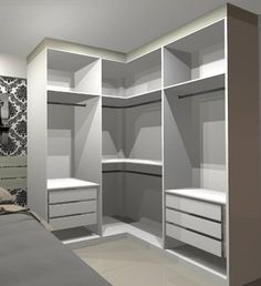 an empty bedroom with white closets and drawers