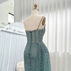 Discover elegance and glamour in the Dreamy Vow Sparkly Crystal Turquoise One Shoulder Evening Dress SS131. Designed for the modern woman, this stunning dress features intricate crystal embellishments and a stylish one shoulder design. Perfect for any special occasion, make a statement and dazzle in this dreamy dress. window.adminAccountId=244214477; Wedding Dress Overskirt, Silver Grey Dress, One Shoulder Evening Dress, Crystal Turquoise, Yellow Evening Dresses, Aqua Mermaid, Silver Evening Dress, Purple Evening Dress, Gold Evening Dresses