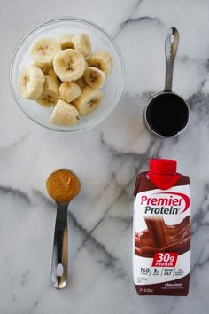 ingredients to make peanut butter and banana smoothie laid out on a marble counter top