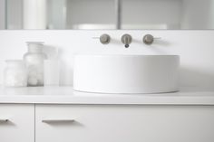 a white bathroom sink sitting on top of a counter