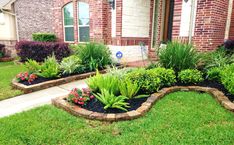 a garden in front of a brick house