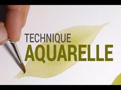 a hand holding a pen and writing on a piece of paper with the words technique aquarellalle