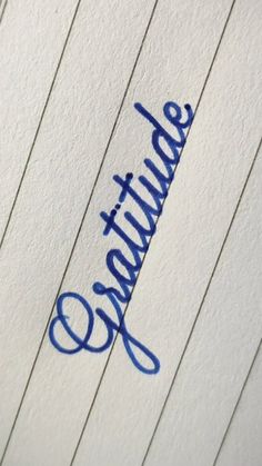 a close up view of the writing on a piece of paper with blue ink in it