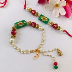 a close up of a bracelet on a table with flowers and other items around it