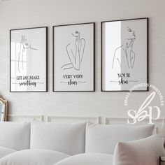 three black and white posters hanging on the wall above a couch in a living room