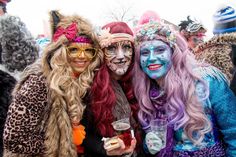 two women dressed up in costumes posing for the camera with their faces painted like cats