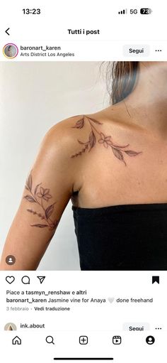 the back of a woman's shoulder with flowers on it and an arrow in the middle