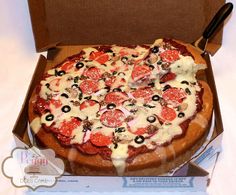 a pizza with pepperoni, olives and cheese in a box