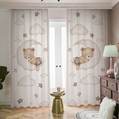 the curtains in this room have teddy bears and stars on them, as well as clouds