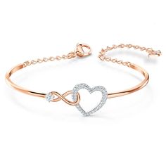 This heart bracelet combines the precision and quality of sparkling crystals with a chic rhodium plated chain, making this endearing look a cute accessory. A single white crystal adorns a dainty infinity sign interlaced with a dazzling white crystal pave heart, adding a brilliant and romantic touch to the simple, refined design. Teen Slang, قلادات متدلية, Heart Bangle Bracelet, Inexpensive Jewelry, Womens Bangles, The Bangles, Swarovski Bracelet, Infinity Heart, Classy Jewelry