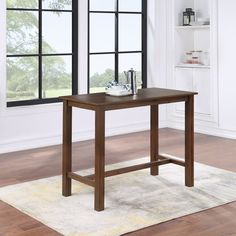 a wooden table sitting on top of a white rug