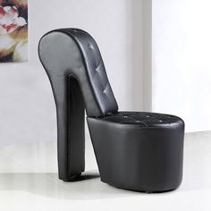 a black chair and foot stool in a room