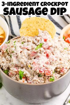 three ingredient crockpot sausage dip in a bowl with tortilla chips on the side