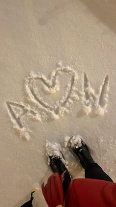 someone is standing in the snow with their feet up and writing i love you on it