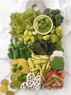 a bunch of food that is laying out on a white counter top with some coins