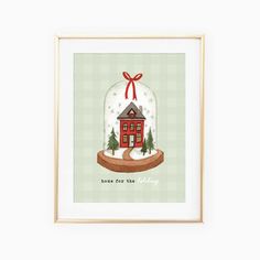 a snow globe with a house in it and a red bow on the top that says home for the holidays