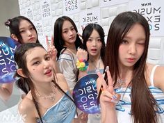 the girls are posing with their hair in braids and one is holding up a sign that says music expo 2013