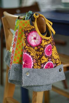 two purses sitting on top of a wooden chair