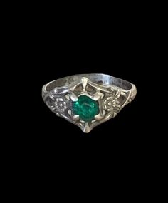 "Unique antique 925 sterling silver child ring with a small simulated emerald in the center. This ring has a small possible emerald in the center with small floral accents embossed on either side. Believed to fit a child, this ring weighs .9g, size 2 and rests at .50\" x .25\". This will make a great addition to any antique jewelers collection or a great gift for you and your loved ones. Take a look at the pictures for the best description. A photo is as good as a thousand words and is the best Heirloom Green Birthstone Ring For May, Heirloom Green May Birthstone Ring, Fine Jewelry Green Signet Ring With Birthstone, Antique Hallmarked Emerald Ring In White Gold, Vintage White Gold Emerald Ring Hallmarked, Vintage Oval Engraved Emerald Ring, Vintage Oval Emerald Ring Engraved, Victorian Silver Jewelry With Birthstone, Classic Silver Emerald Birthstone Ring