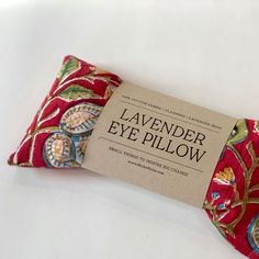 a red pillow with a label that says lavender eye pillow on it's side