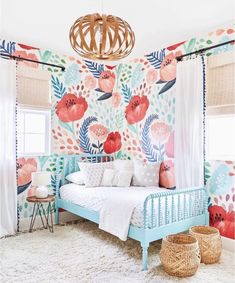 a bedroom with floral wallpaper and blue bed