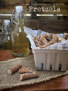 there is a basket full of pretzels next to a bottle of oil on the table