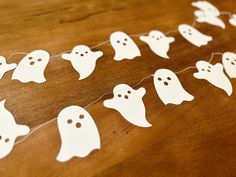 paper ghost garland on wooden table with string