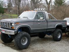 a gray truck parked on top of a driveway