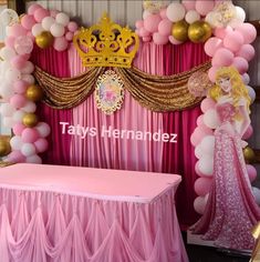 a pink and gold princess themed birthday party with balloons, streamers, table cloths, and decorations