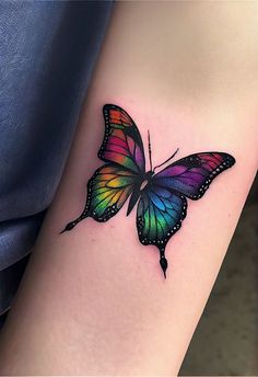 a colorful butterfly tattoo on the leg