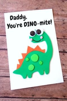 a father's day card with a green and orange dinosaur on it, says daddy you're dino - mite