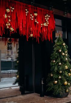 a christmas tree and decorations in front of a building