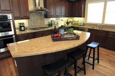 35 Curved Kitchen Island Ideas (Photos) - Home Stratosphere Kitchen Countertop Trends, Round Kitchen Island, Kitchen Island With Granite Top, Hardwood Floors In Kitchen, Granite Island