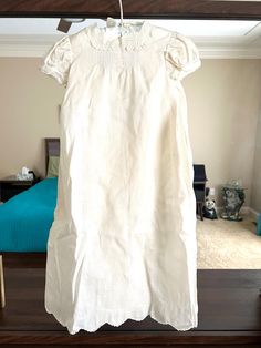 This Christening gown has two pieces. One is the gown and the other one is the slip for inside the gown. It has lace on the collar, sleeves, and bottom of the gown. Trims with pin tucks down on the back. Embroidery on the front, and the bottom of the gown. Three buttons on the back and two buttons on top of the slip. The tag on the dress says Hand Made. Not exactly what size this dress is. It measures 26" long and 12" wide. 8-1/2" chest across. Not sure when it was made. Handkerchief linen fabric. Hanger not included. Condition: There's one 1/4" spot on top next to the button (back of the dress) and two small spots (1/8" and 1/16") on middle left back of the dress. No tears or rips. It is in very good condition as shown in the photo. Seller Notes: I include photos of each item, so you can Elegant Spring Baptism Dress With Lace Collar, Cream Short Sleeve Fitted Baptism Dress, Elegant Baptism Dress With Lace Trim For Daywear, Elegant Baptism Dress With Lace Trim, Cream Baptism Dress With Lace Collar, Fitted Baptism Dress With Lace Trim, Fitted Baptism Dress With Lace Trim For Daywear, Baby Christening Gowns, Vintage Baby Dresses