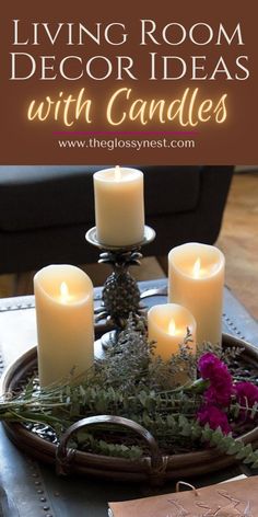 living room decorated with candles and greenery on a tray in front of a couch