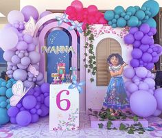 the balloon arch is decorated with purple, blue and pink balloons