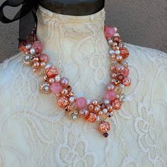 Copper Designer Inspired Twisted Wire Statement Necklace is made with a variety of beads and pearls in various shapes and shades of Pink and Copper. Many of the beads are acrylic so the piece is virtually weightless and Nickle Free.*** Beads and Pearls*** 18, 20 or 22 Inches in length with a Rhinestone Magnetic Clasp*** Twisted Wire*** Free Matching Dangle Earrings*** Free US Shipping*** Ships in 1 Day*** Gift Wrapping AvailableThis necklace was inspired by my favorite Designer Pearl Necklace bu Pink Pearl Necklaces With Polished Beads, Pink Pearl Necklace With Polished Beads, Party Pearl Necklace With Large Beads, Pearl Necklaces With Colorful Beads For Party, Pearl Necklace With Colorful Beads For Party, Party Pearl Necklace With Colorful Beads, Elegant Pink Pearl Necklace With Colorful Beads, Pearl Necklaces With Large Beads For Gifts, Pink Pearl Beaded Necklaces For Parties