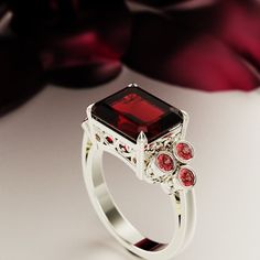 a fancy ring with red stones on it