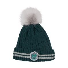 a green hat with a white pom - pom