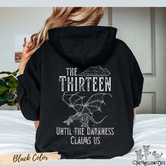 OFFICIALLY LICENSED Sarah J. Maas Merch Throne of Glass The Thirteen hoodie is the perfect gift for every Book lover.  The Throne of Glass TOG Hoodie is a perfect addition to any wardrobe and a cool booklover gift idea. A cute Trendy hoodie with Groovy Design Aesthetic Crewneck will be an amazing gift for every friend or family member. A unisex heavy blend hooded sweatshirt is relaxation itself. The material is a thick blend of cotton and polyester. This makes for a plush, soft feel alongside wa Pop Culture Black Hoodie Sweatshirt, Black Pop Culture Crew Neck Hoodie, Black Pop Culture Hoodie Sweatshirt, Black Pre-shrunk Band Merch Hoodie, Band Merch Crew Neck Hoodie For Fan Merchandise, Band Merch Crew Neck Hoodie For Fans, Black Band Merch Sweatshirt Pre-shrunk, Black Band Merch Sweatshirt, Pre-shrunk, Throne Of Glass The Thirteen