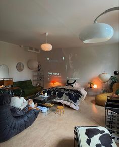 a living room filled with lots of furniture and decor on top of carpeted flooring