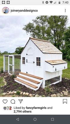 a white chicken coop with steps leading up to it