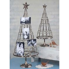 two metal christmas trees with pictures on them